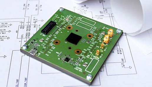 Circuit board lying on a schematic